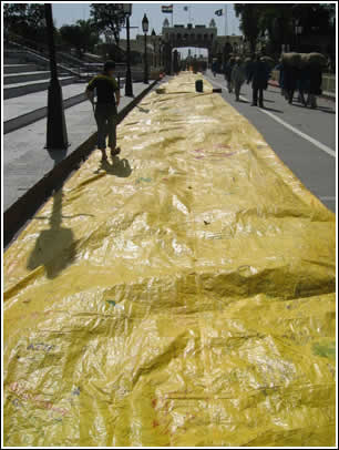 All four yellow strips of the World's Largest Love Letters are laid out linearly, stretching from Pakistan to India across Wagah Border. 