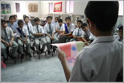 A Pakistani Boy reads aloud a letter from an Indian boy. 
